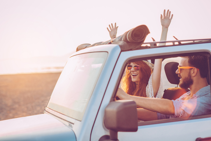 A couple ride in a jeep