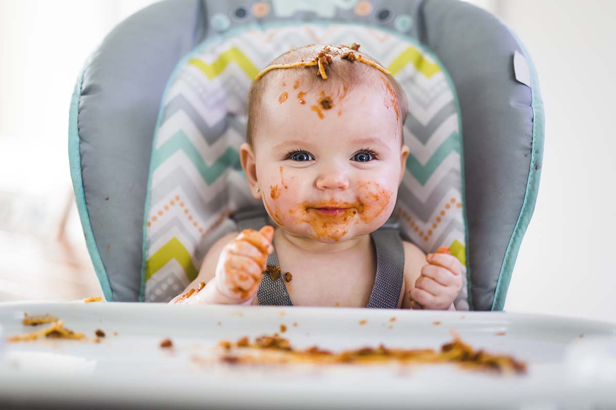 Young kid with spaghetti all over him