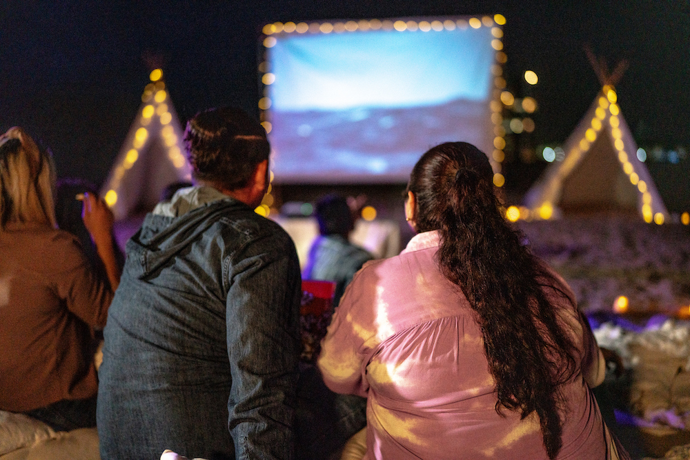 outdoor movie, movie, watching a movie, string lights, outside