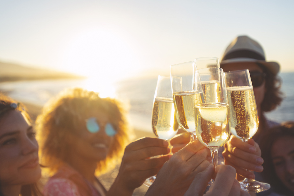 people clinking glasses at happy hour