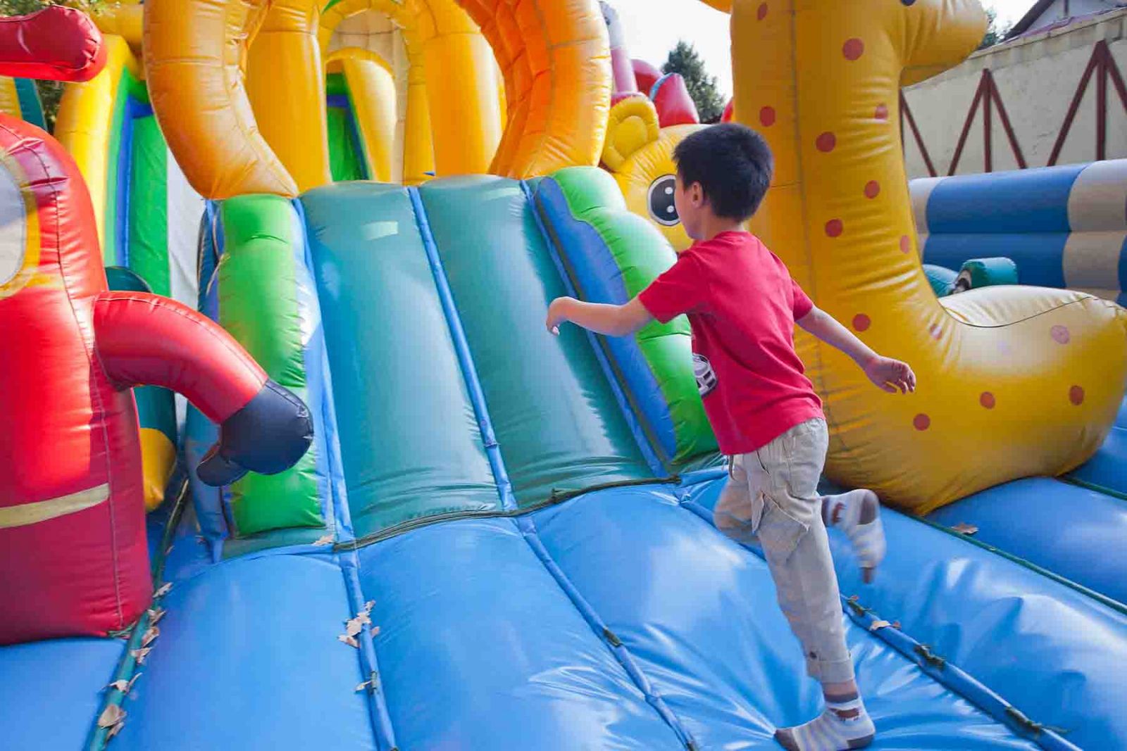 Young boy enjoying an inflatable bouncy house