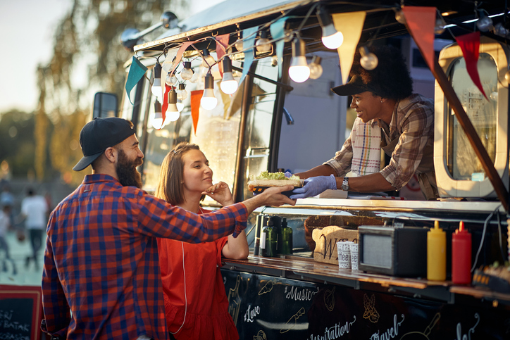 A couple order from a food truck